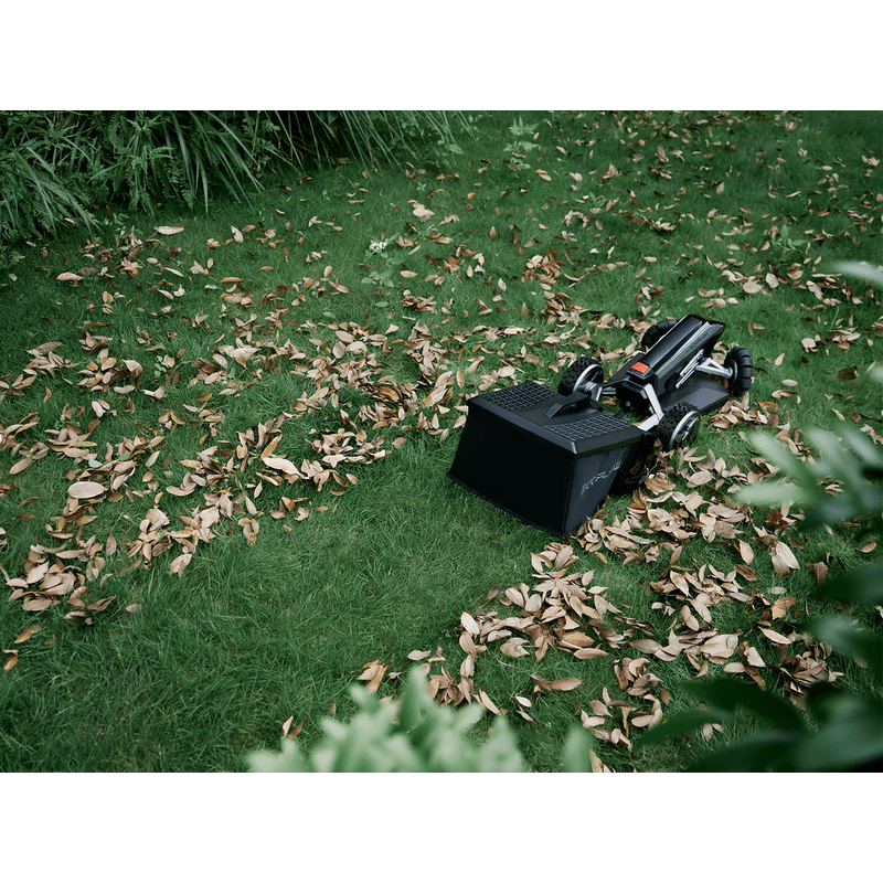 Lawn Sweeper actively collecting leaves from yard flawlessly