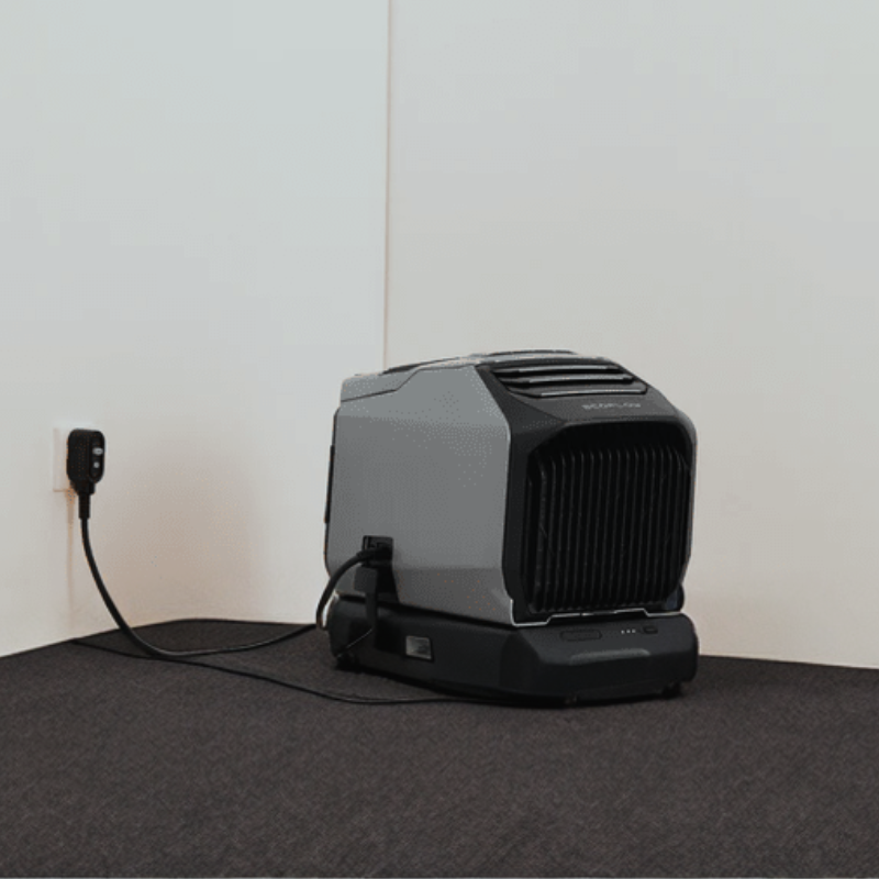 EcoFlow Wave 2 Portable AC Heater Unit: Rapidly charging from an AC wall outlet, nestled in the corner of a room
